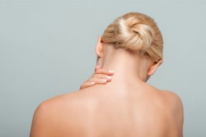 The woman suffers from neck pain.